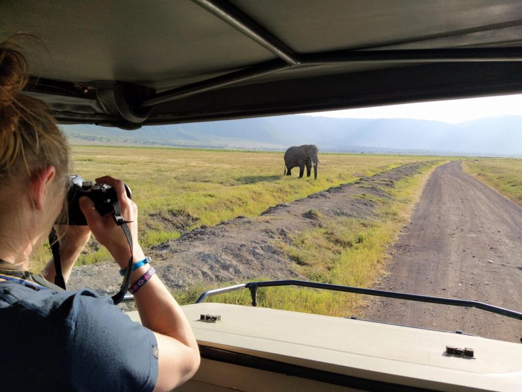 Tourist photographing elephant on our 8 days Kenya & Tanzania safari