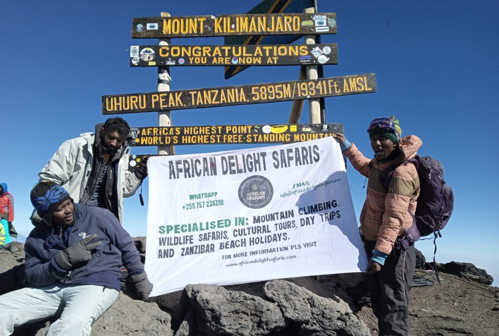 3 PEOPLE ON THE SUMMIT OF MT. KILIMANJARO