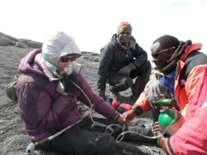 hiker receiving bottled oxygen due to altitude sickness