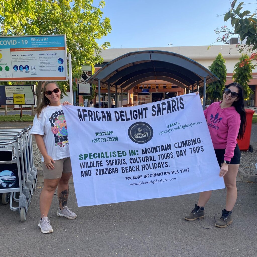 CLIENTS POSING WITH OUR COMPANY BANNER