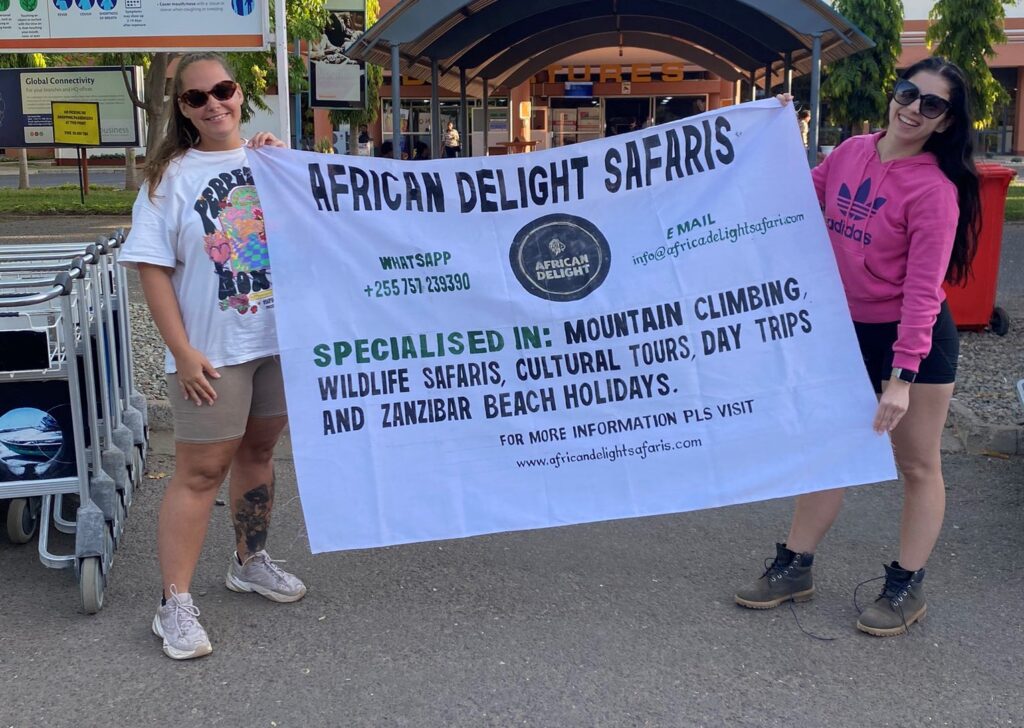 CLIENTS POSING WITH OUR COMPANY BANNER