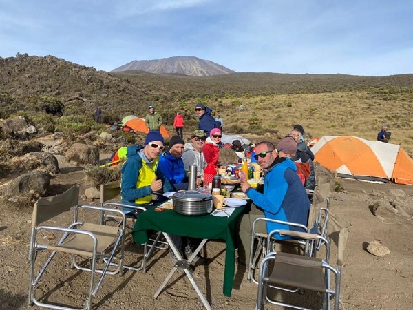 a group of hikers enjoying breakfast on Kilimanjaro