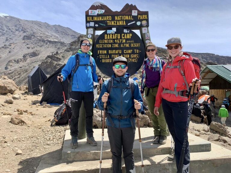 3 men standing infront of kilimanjaro barafu camp