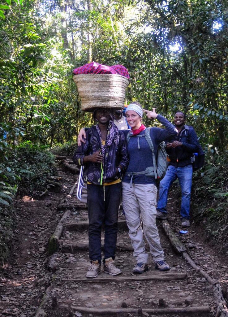 Our Kilimanjaro Porter posing for a picture with client