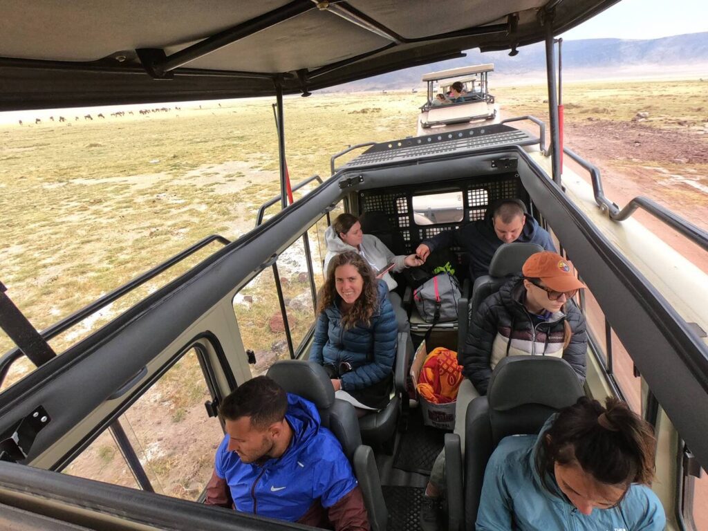 Tanzania group safari tourists in vehicle enroute Serengeti