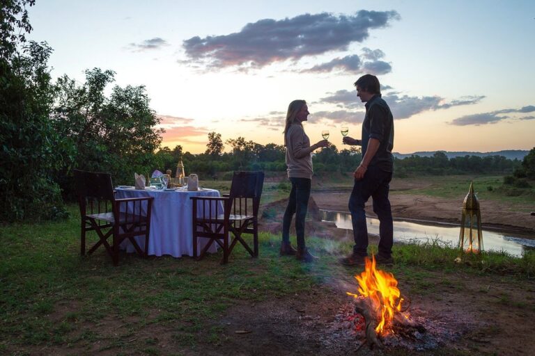 tanzania couple out in Serengeti by campfire