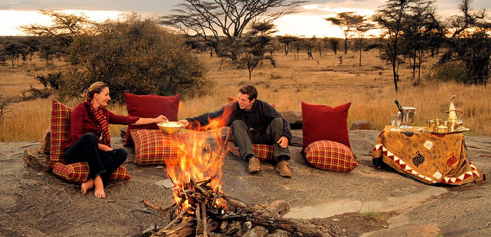 enjoying campfire on luxury safari cam tours in Tanzania