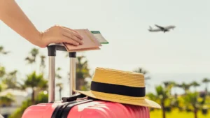 traveller with bags and passport looking at a plane above