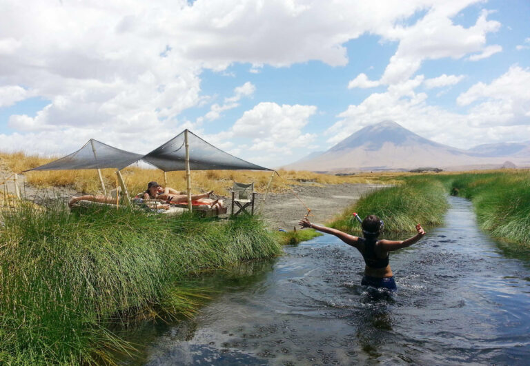 Tourists swimming at a spring in lake natron day trip in Arusha